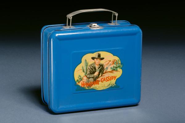 A blue lunch box with a cowboy on the front.