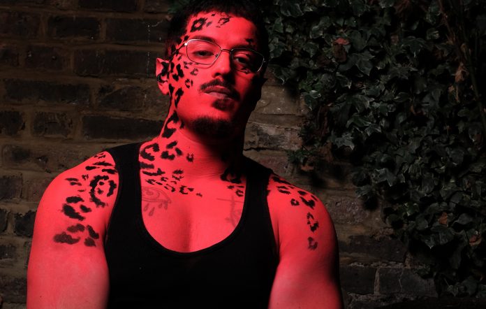 Babymorocco photographed in a red hue and leopard prints on his skin, photo by Charlie Baldwin