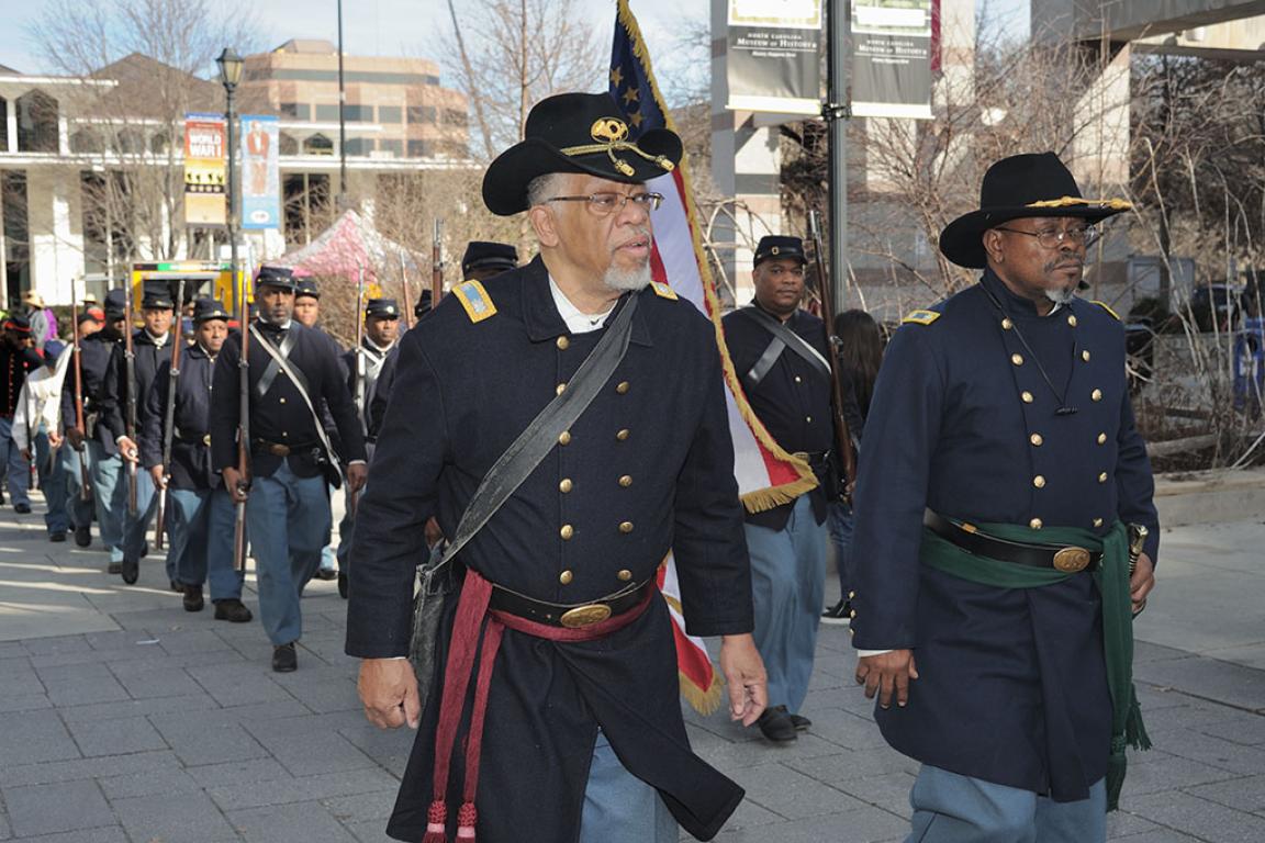 African American Civil War reenactors marching the plaza