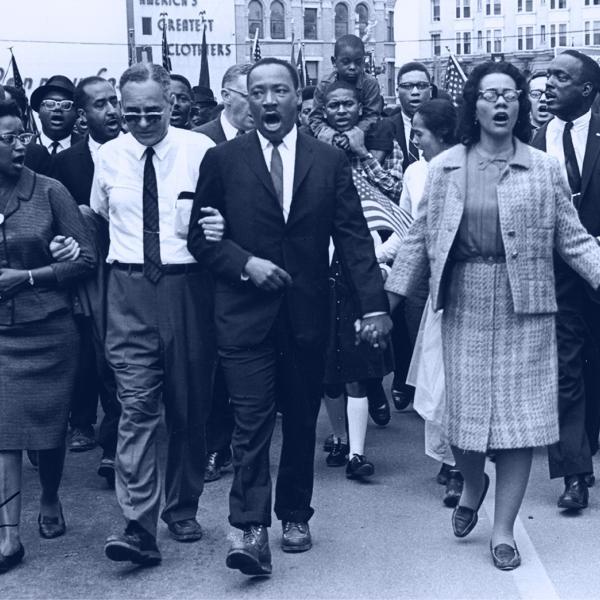 Martin Luthor King, Jr and his supporters marching through Selma