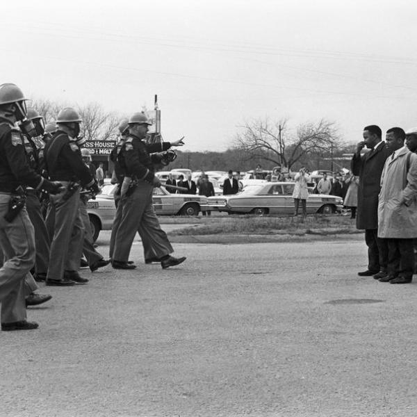 Police officers lined up and giving warning
