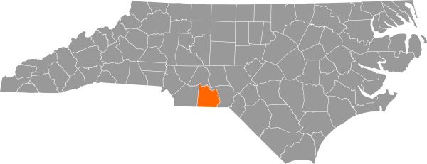 A gray map of North Carolina with Anson County filled in with orange.