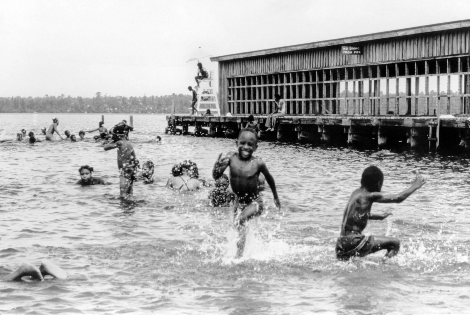 Children play in the waters of Jones Lake State Park, (Bladen County), circa. 1950.  The site was the first state park open to people of color.  Courtesy North Carolina State Parks